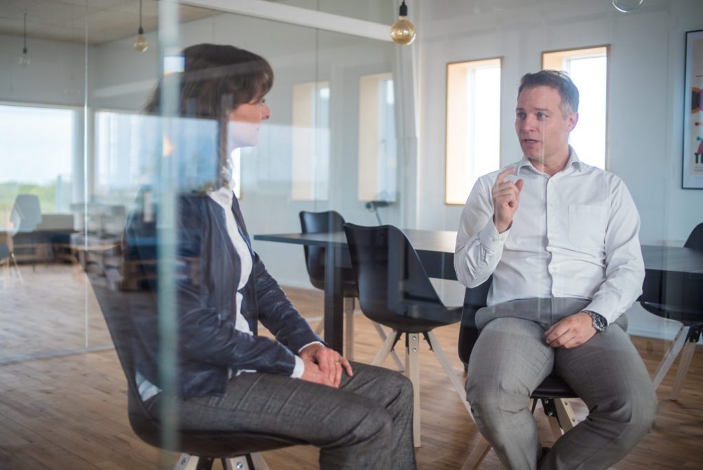 Danish Executive being interviewed by Claudia Lindby, Executive Coach in a glass room