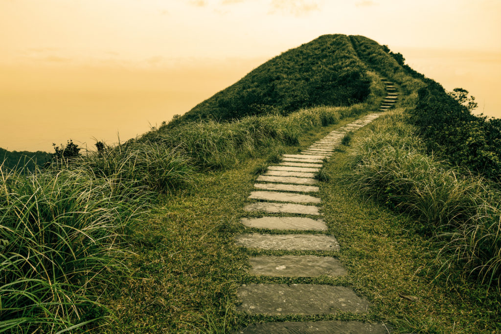 Fairy tale landscape and stepping stone path over a hill on the horizon at the Caoling Historic Trail in Taiwan